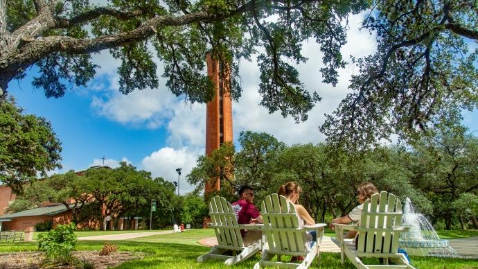 Students studying in front of fountain