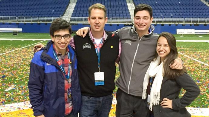 Trinity interns on Valero Bowl field after the game