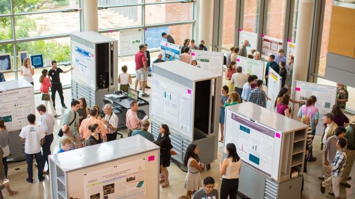 dozens of students present undergraduate research posters in the CSI cube