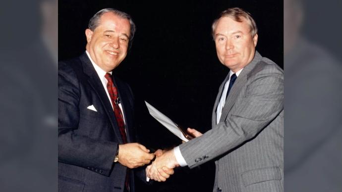 Ken Taggart (left) shakes hands with the late President Emeritus Ron Calgaard