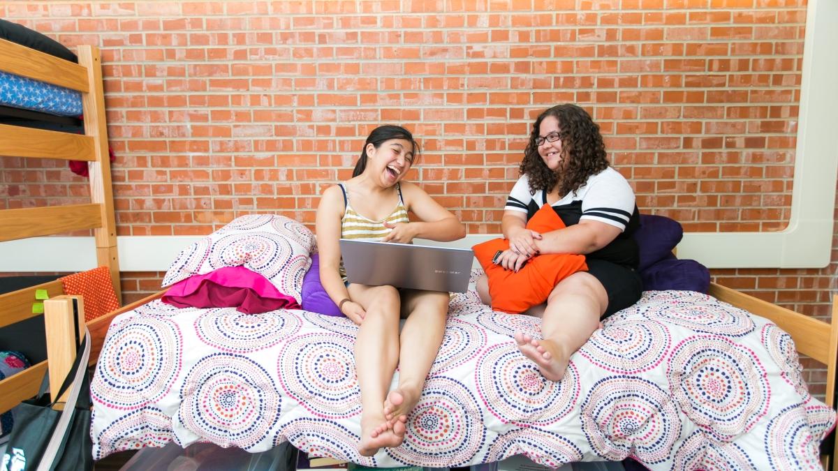 Two students inside of the Witt-Winn Hall dorm room studying