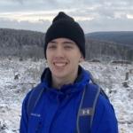 Headshot of Tim Mose with a snowy scene in the background